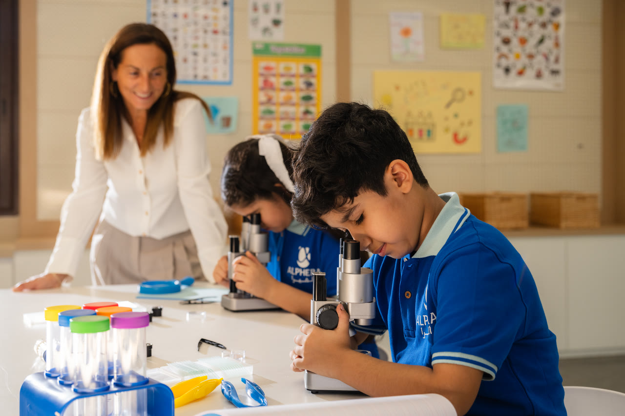 Learners use microscopes during a science lab activity.
